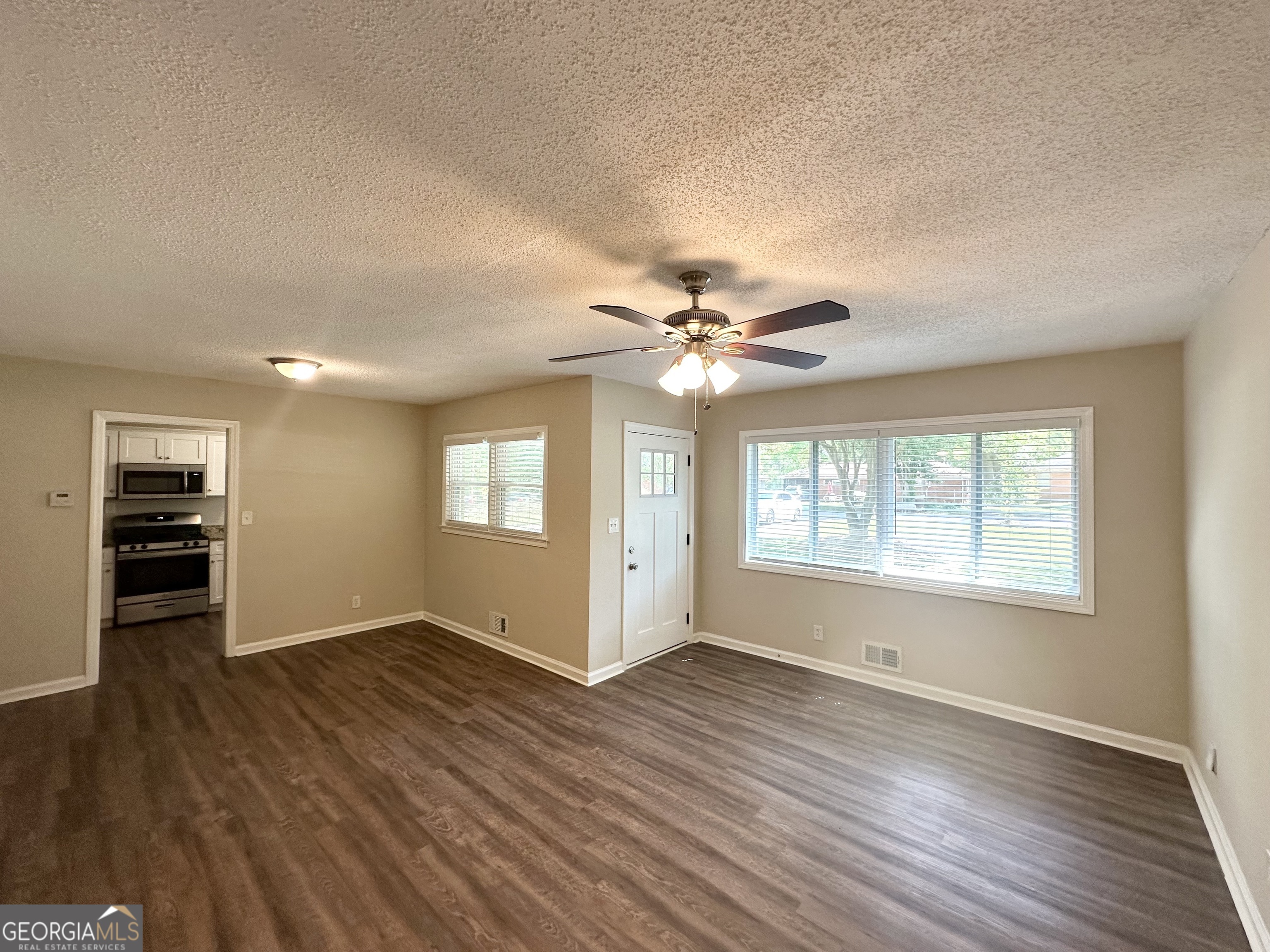1089 Canal Street Decatur, GA 30032 - Photo 4 of 18 a view of an empty room with a window and wooden floor