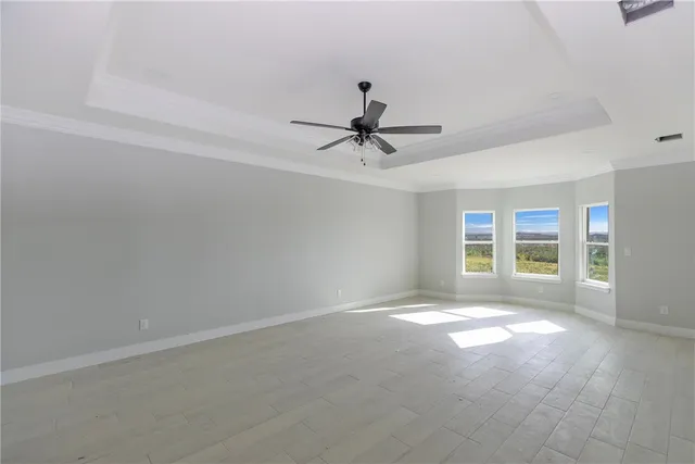 a view of a livingroom with a ceiling fan and window
