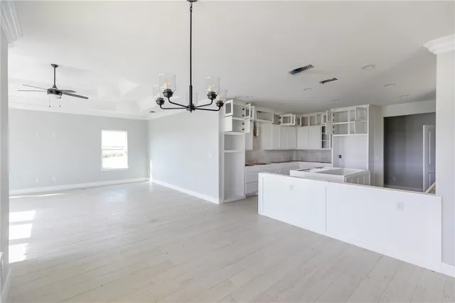 a large kitchen with kitchen island a sink stainless steel appliances and cabinets