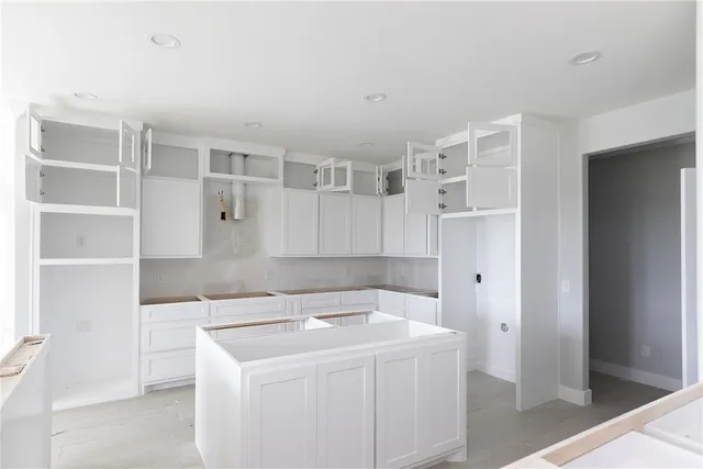 a utility room with cabinets washer and dryer