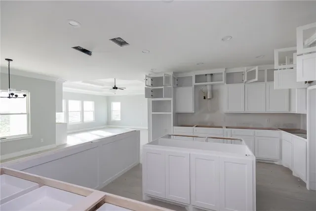 a utility room with cabinets washer and dryer