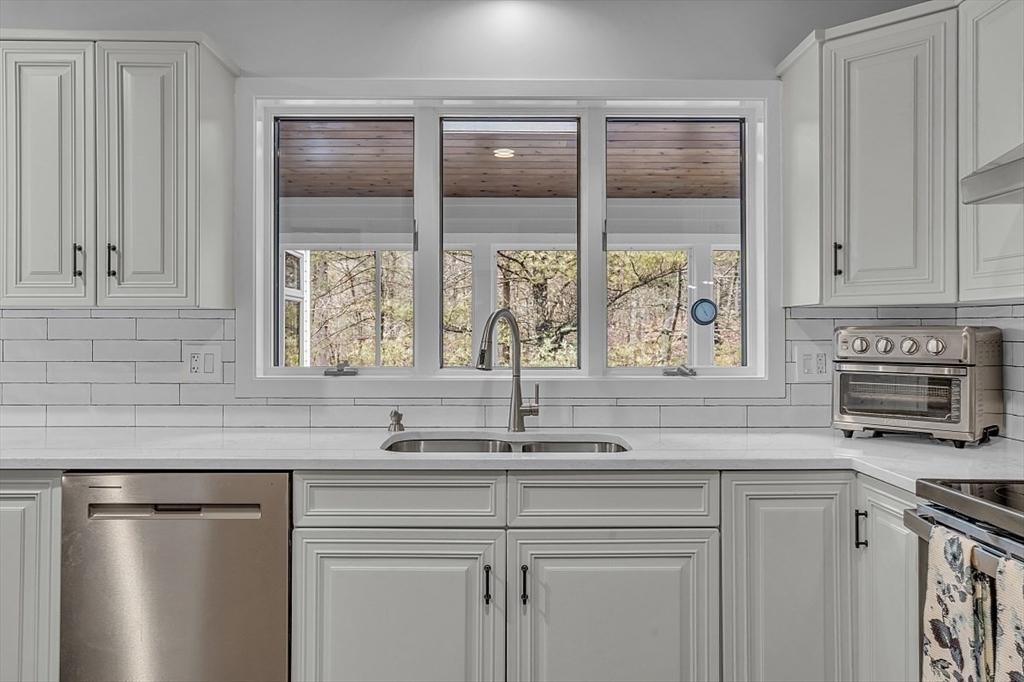 80 Elizabeth Ridge Road Carlisle, MA 01741 - Photo 12 of 33 a kitchen with granite countertop a sink and a window