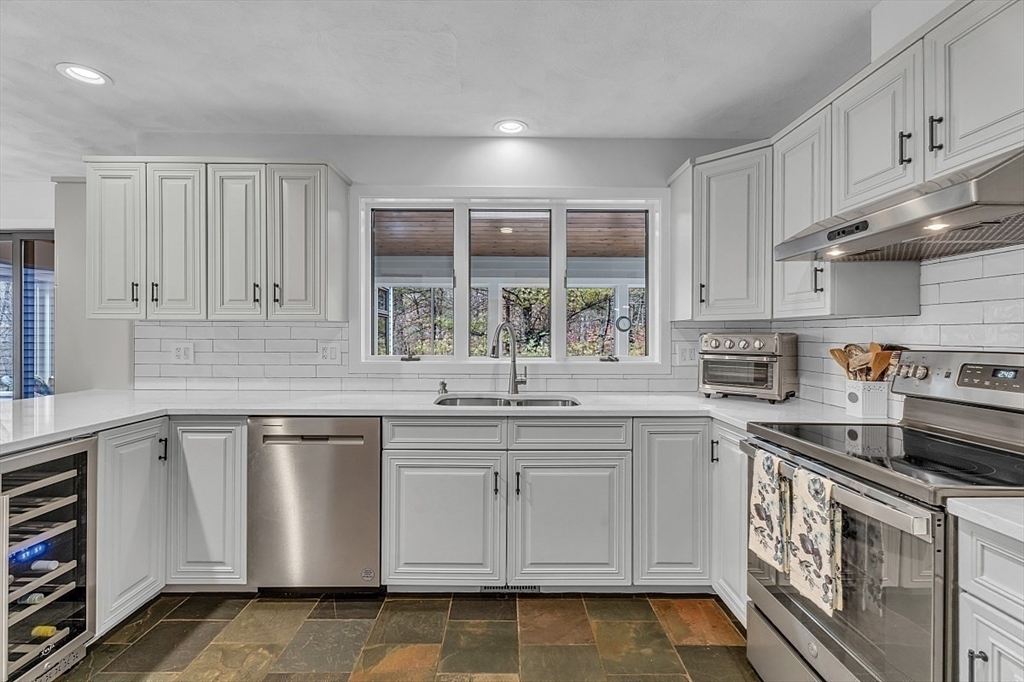 80 Elizabeth Ridge Road Carlisle, MA 01741 - Photo 14 of 33 a kitchen with granite countertop white cabinets and white appliances