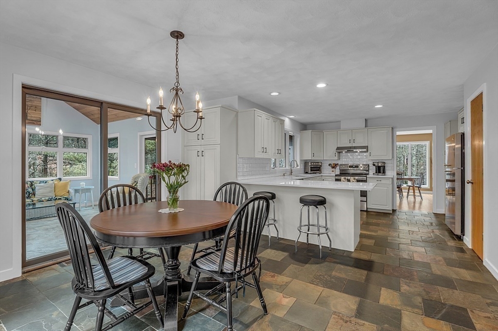 80 Elizabeth Ridge Road Carlisle, MA 01741 - Photo 15 of 33 a dining room filled chandelier and kitchen view