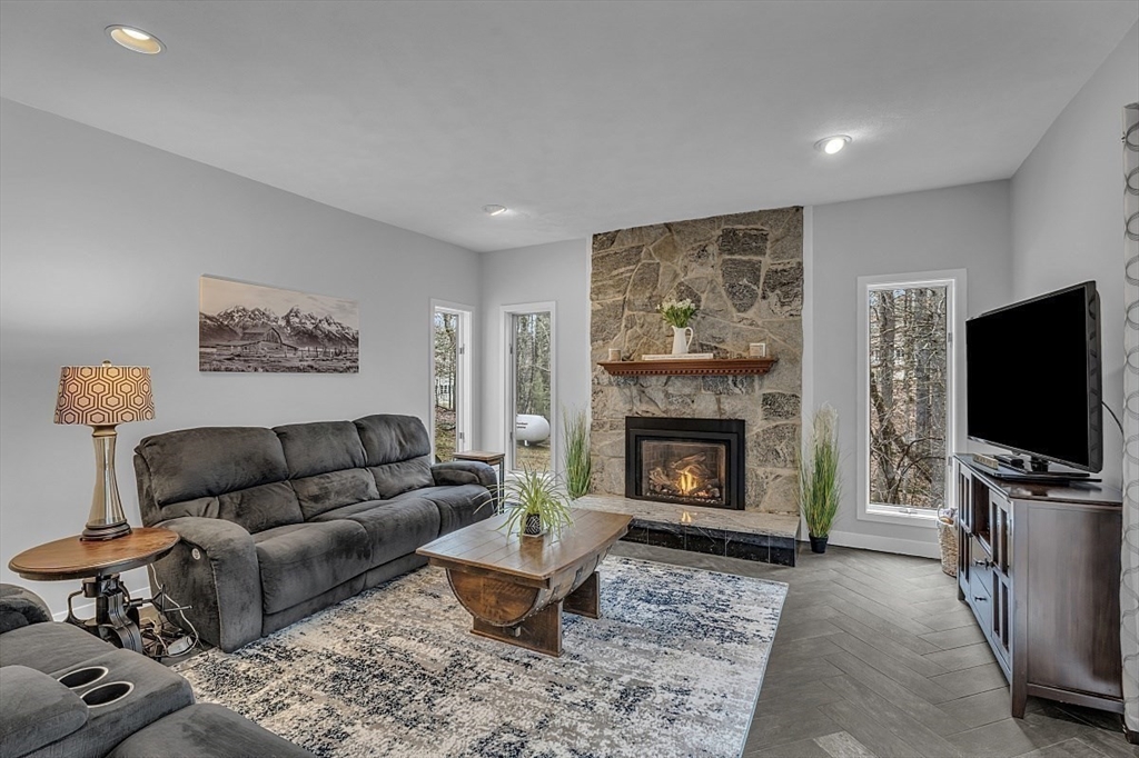80 Elizabeth Ridge Road Carlisle, MA 01741 - Photo 18 of 33 a living room with furniture a flat screen tv and a fireplace