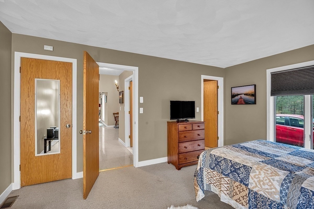 80 Elizabeth Ridge Road Carlisle, MA 01741 - Photo 20 of 33 a bedroom with a bed and a television