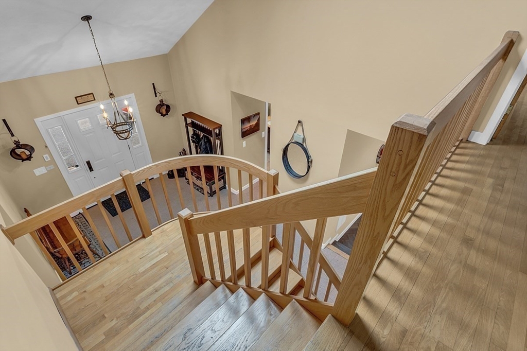 80 Elizabeth Ridge Road Carlisle, MA 01741 - Photo 21 of 33 a view of staircase with lots of frames on wall and wooden floor