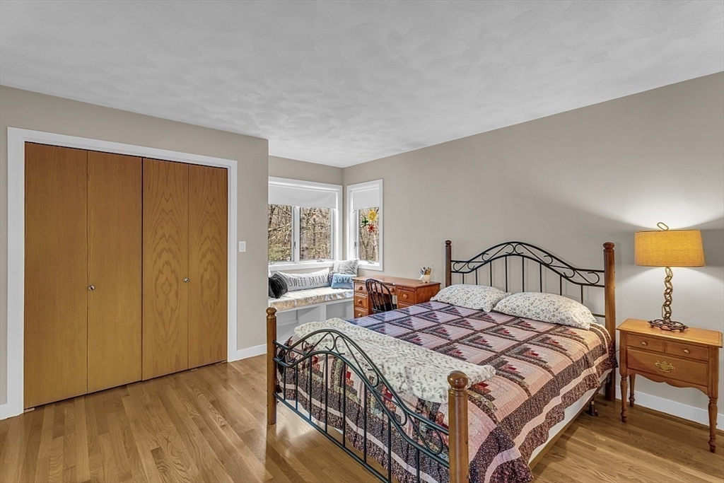 80 Elizabeth Ridge Road Carlisle, MA 01741 - Photo 22 of 33 a bedroom with a bed a lamp on table and a window