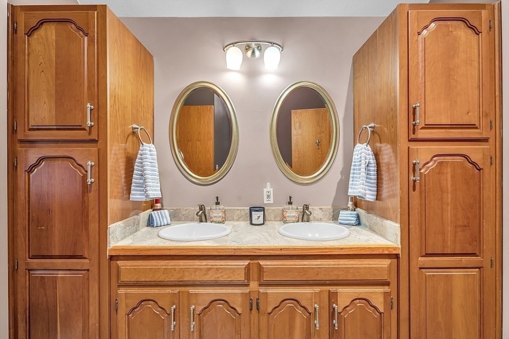 80 Elizabeth Ridge Road Carlisle, MA 01741 - Photo 25 of 33 a bathroom with a double vanity sink and a mirror