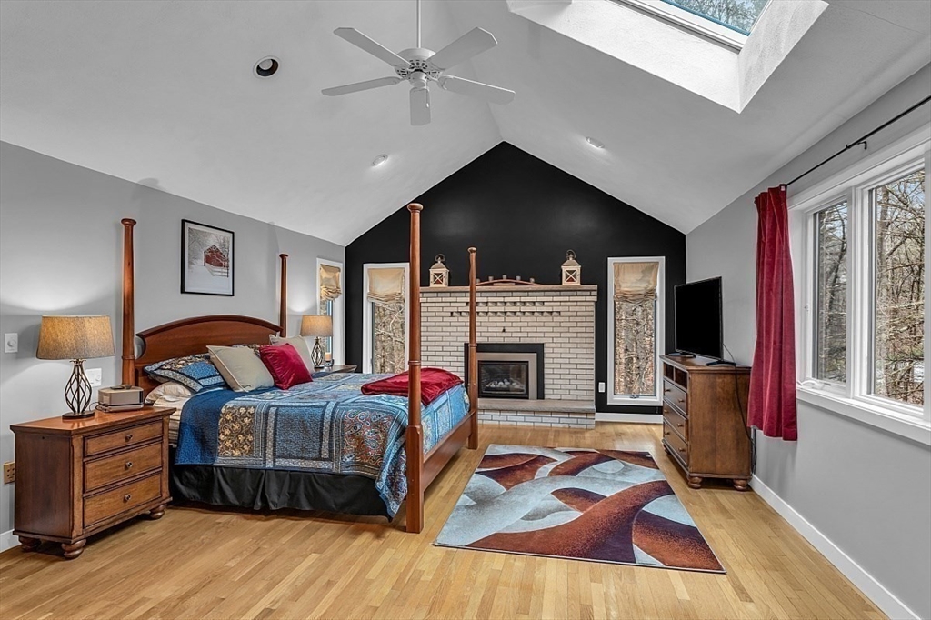 80 Elizabeth Ridge Road Carlisle, MA 01741 - Photo 27 of 33 a bedroom with furniture and a fireplace