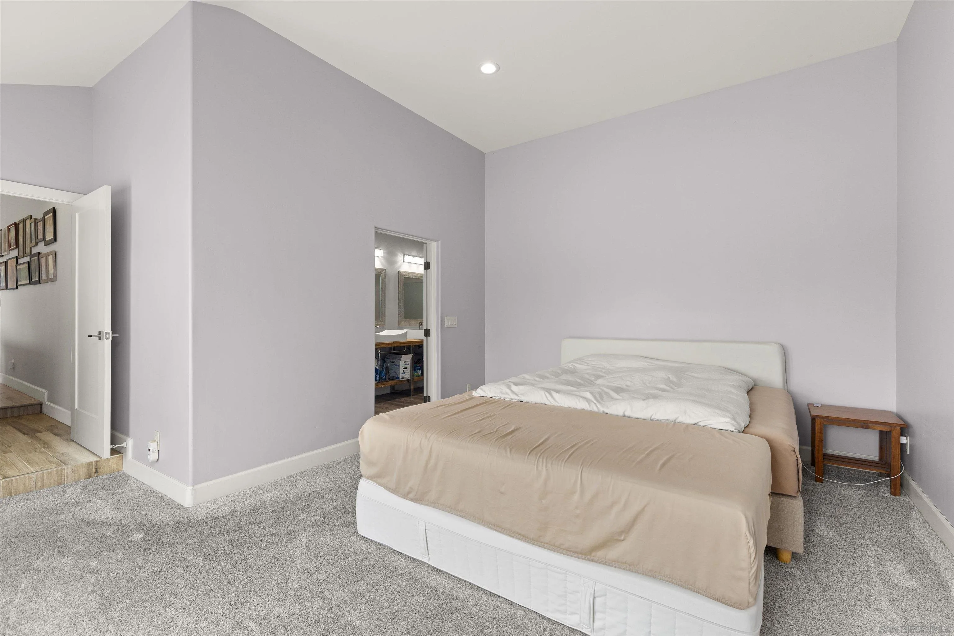 752 Bracero Road Encinitas, CA 92024 - Photo 19 of 46 a bedroom with a bed and a view of bathroom