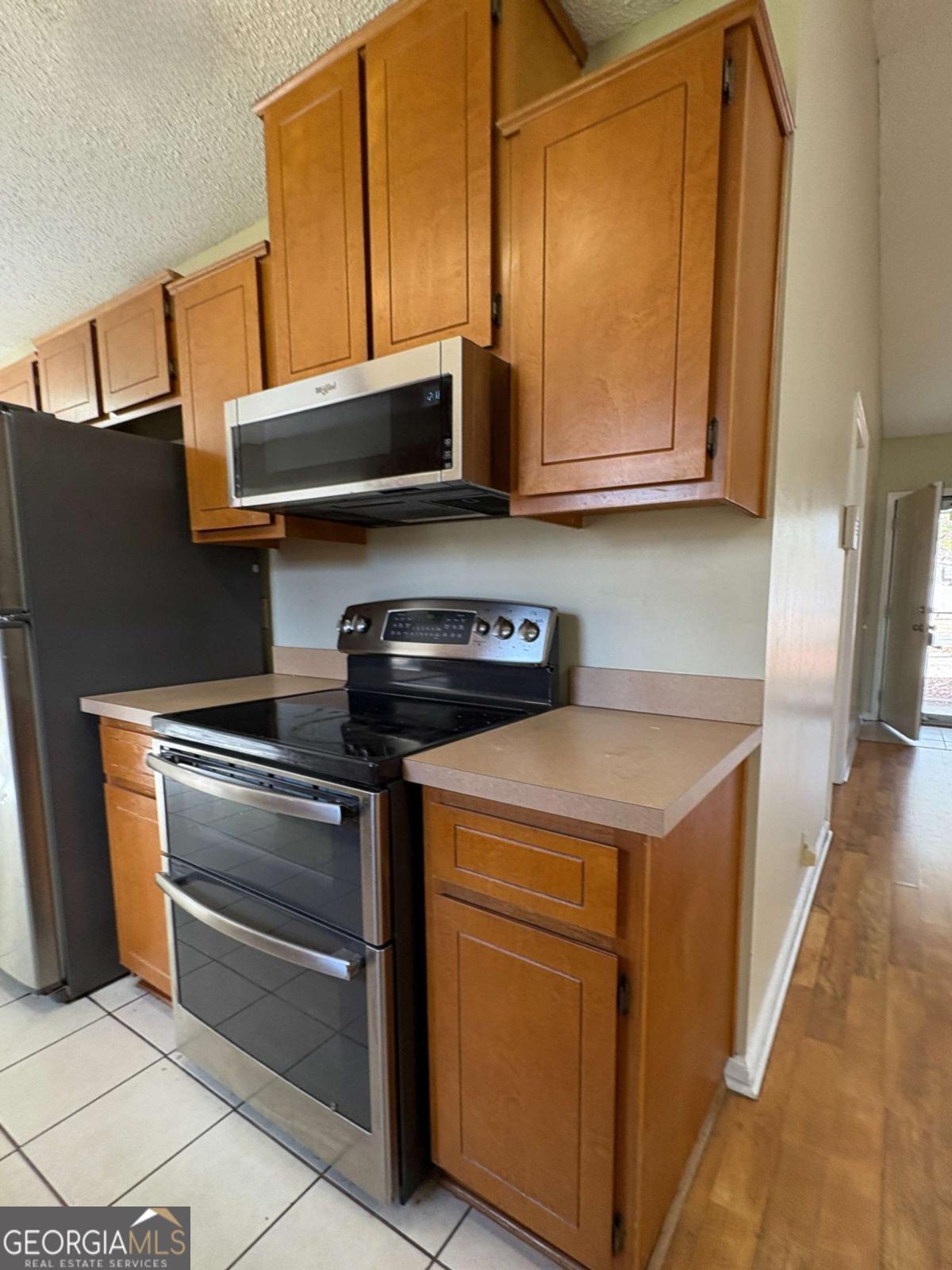317 Lake View Drive Kingsland, GA 31548 - Photo 15 of 51 a kitchen with stainless steel appliances granite countertop a stove and a microwave
