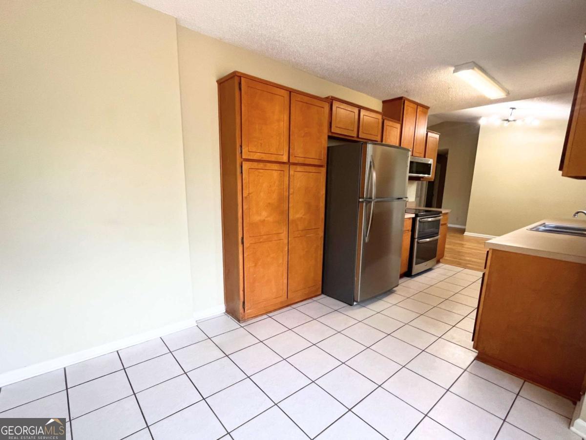 317 Lake View Drive Kingsland, GA 31548 - Photo 17 of 51 a kitchen with refrigerator and cabinets