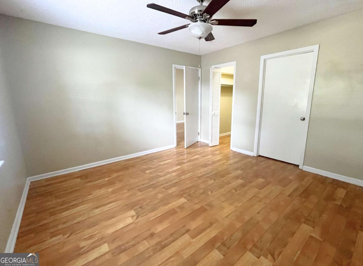 317 Lake View Drive Kingsland, GA 31548 - Photo 18 of 51 a view of a big room with wooden floor and windows in a room