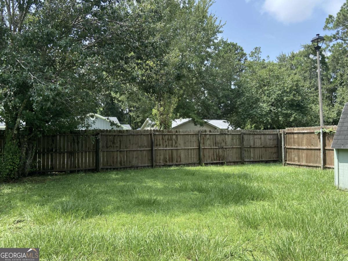 317 Lake View Drive Kingsland, GA 31548 - Photo 34 of 51 a view of a yard with wooden fence