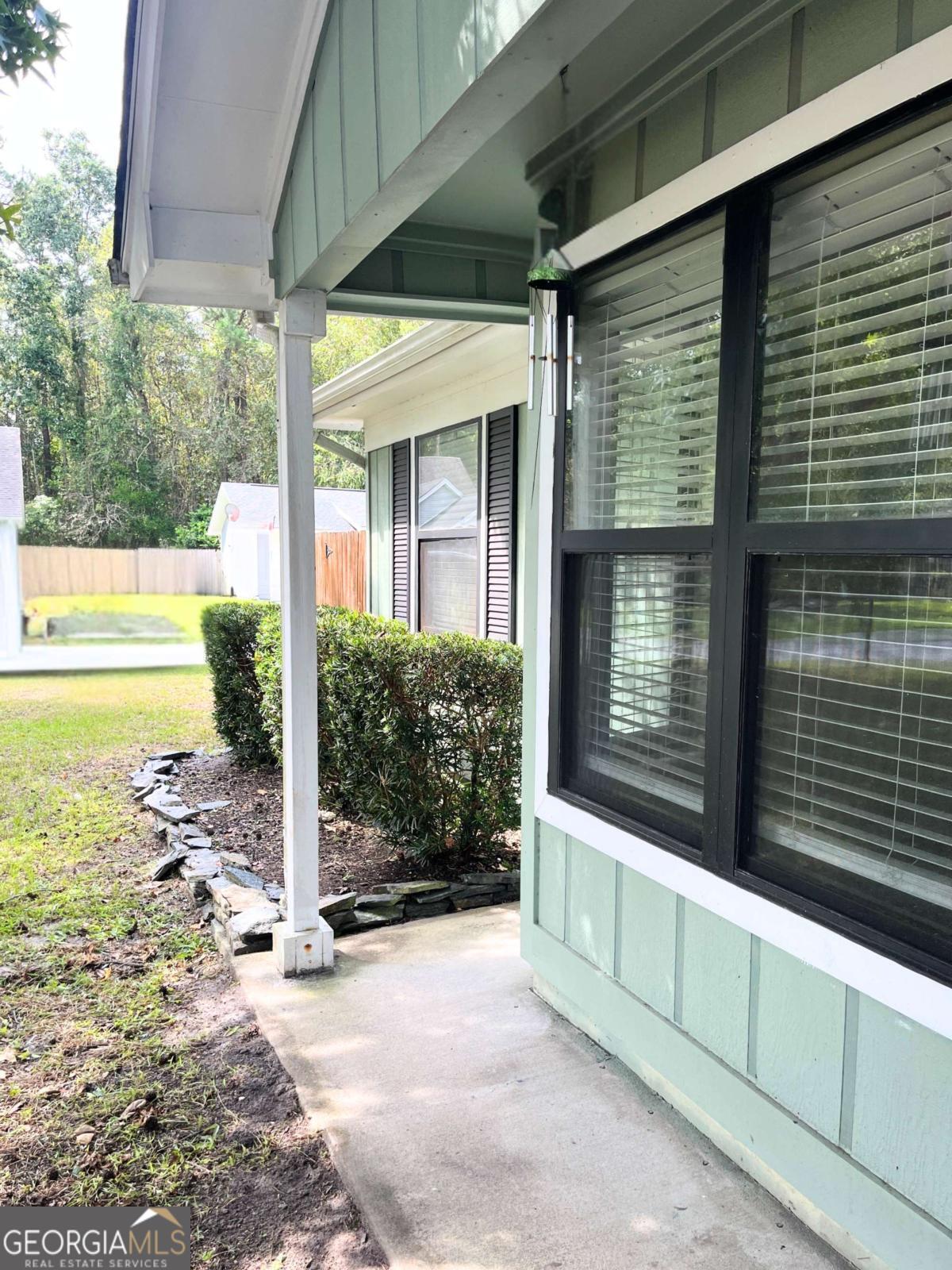 317 Lake View Drive Kingsland, GA 31548 - Photo 6 of 51 a view of a porch with a floor to ceiling window and wooden fence