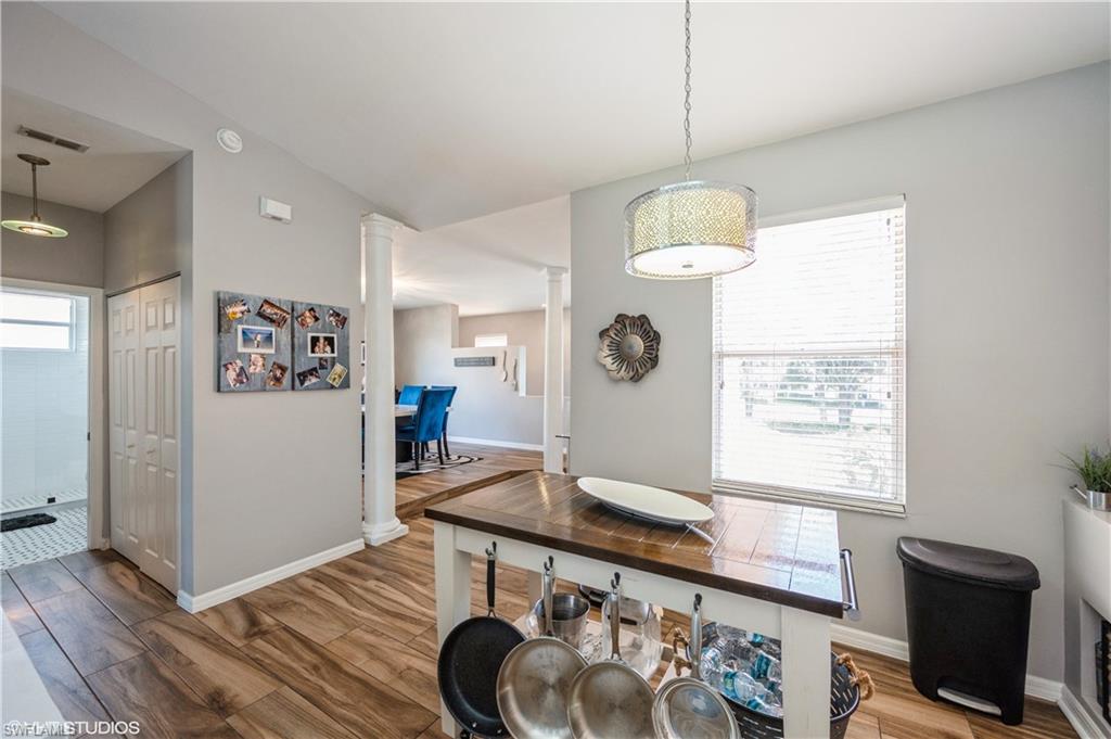 290 Robin Hood Circle, Unit 202 Naples, FL 34104 - Photo 18 of 38 a living room with a couch and a table