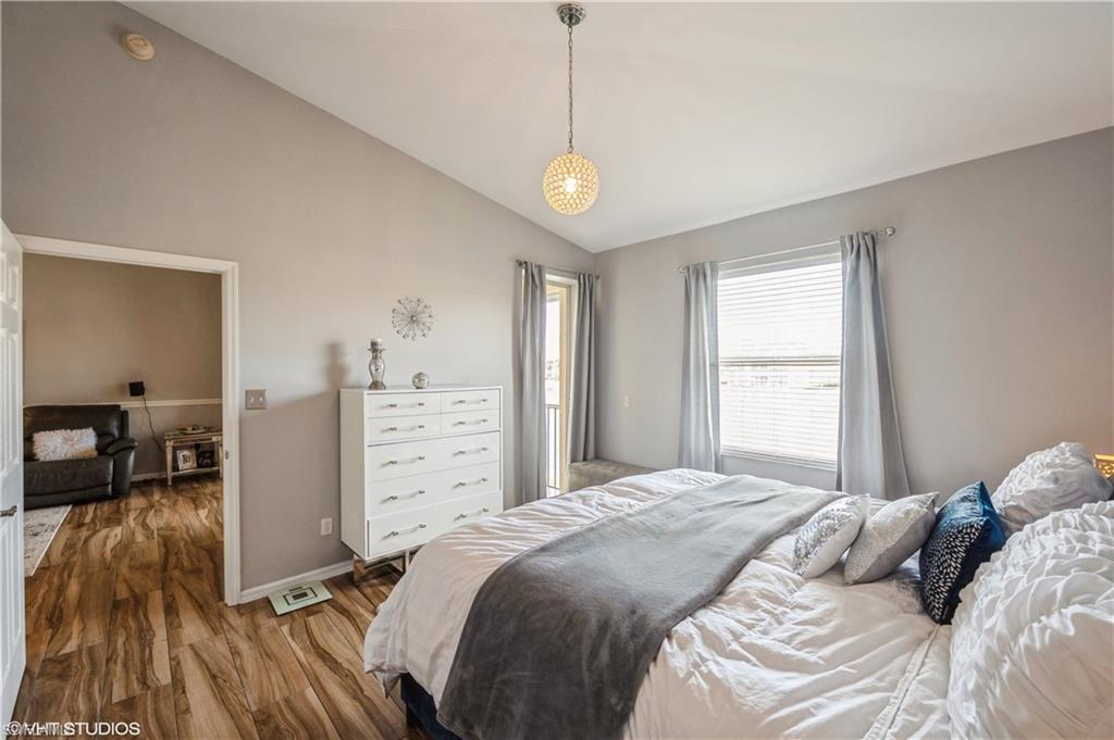 290 Robin Hood Circle, Unit 202 Naples, FL 34104 - Photo 27 of 38 a bedroom with a bed and a view of living room