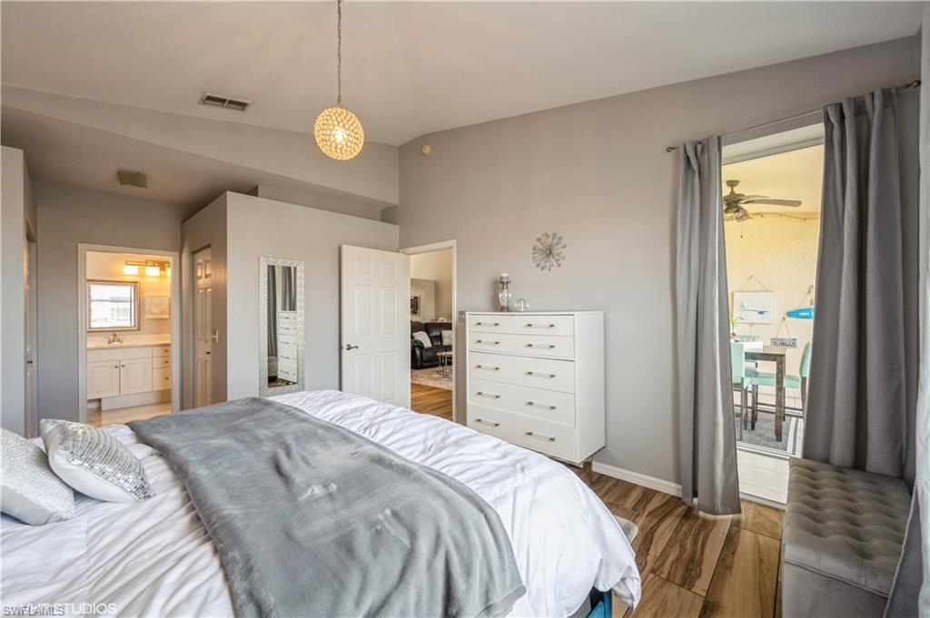 290 Robin Hood Circle, Unit 202 Naples, FL 34104 - Photo 29 of 38 a bedroom with a bed and a window