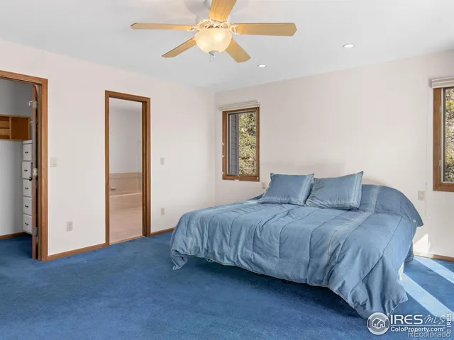 a living room with a bed furniture and a window