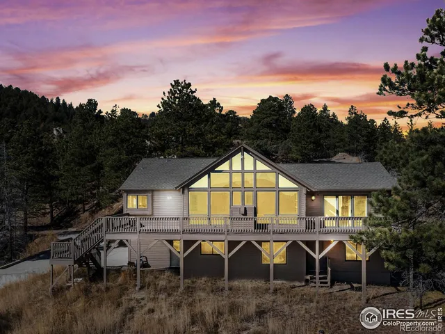 an aerial view of a house with swimming pool and porch