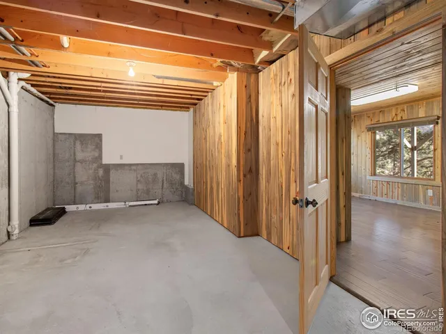 a view of a hallway with wooden floor and entryway