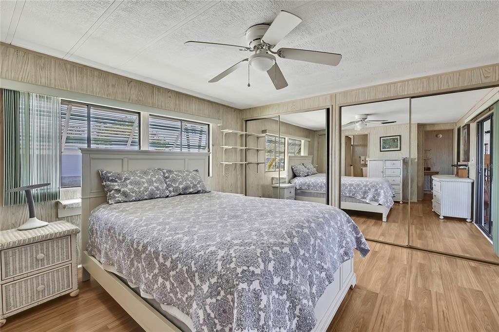 3141 Nantucket Drive Holiday, FL 34690 - Photo 11 of 34 a bedroom with a large bed and a chandelier