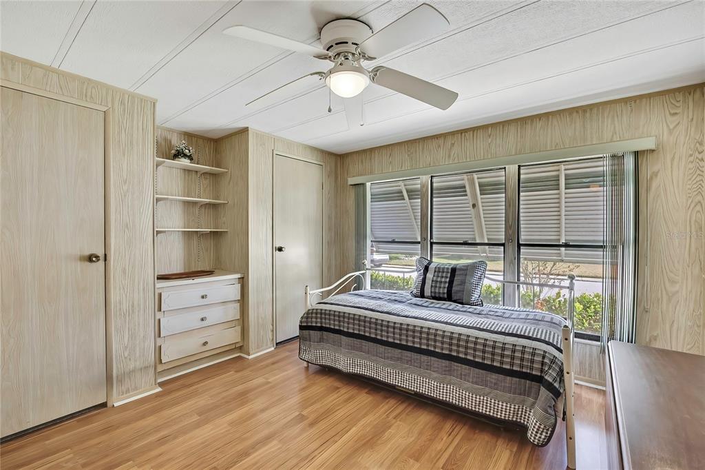 3141 Nantucket Drive Holiday, FL 34690 - Photo 16 of 34 a bedroom with a bed a chandelier and large window
