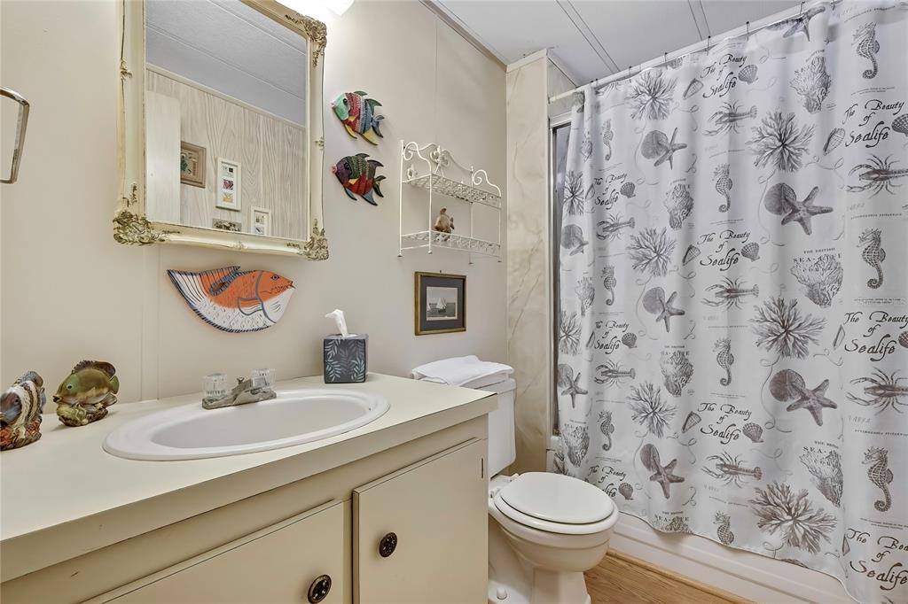 3141 Nantucket Drive Holiday, FL 34690 - Photo 18 of 34 a bathroom with a granite countertop sink and a toilet