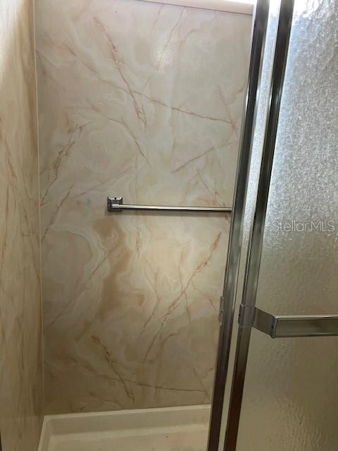 3141 Nantucket Drive Holiday, FL 34690 - Photo 22 of 29 a bathroom with a glass shower door