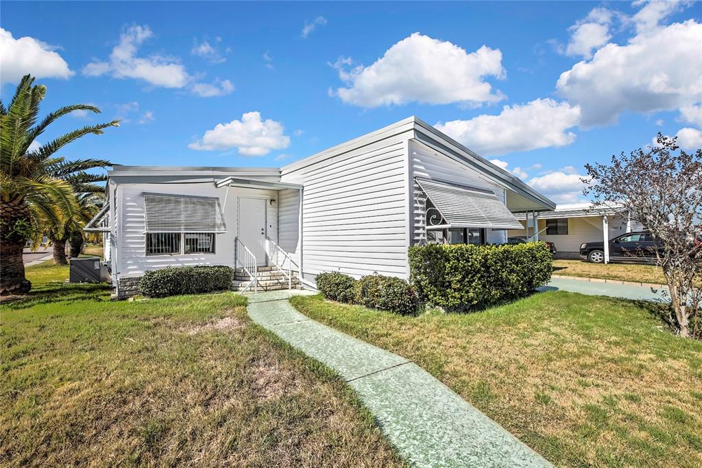 3141 Nantucket Drive Holiday, FL 34690 - Photo 25 of 34 a front view of a house with garden