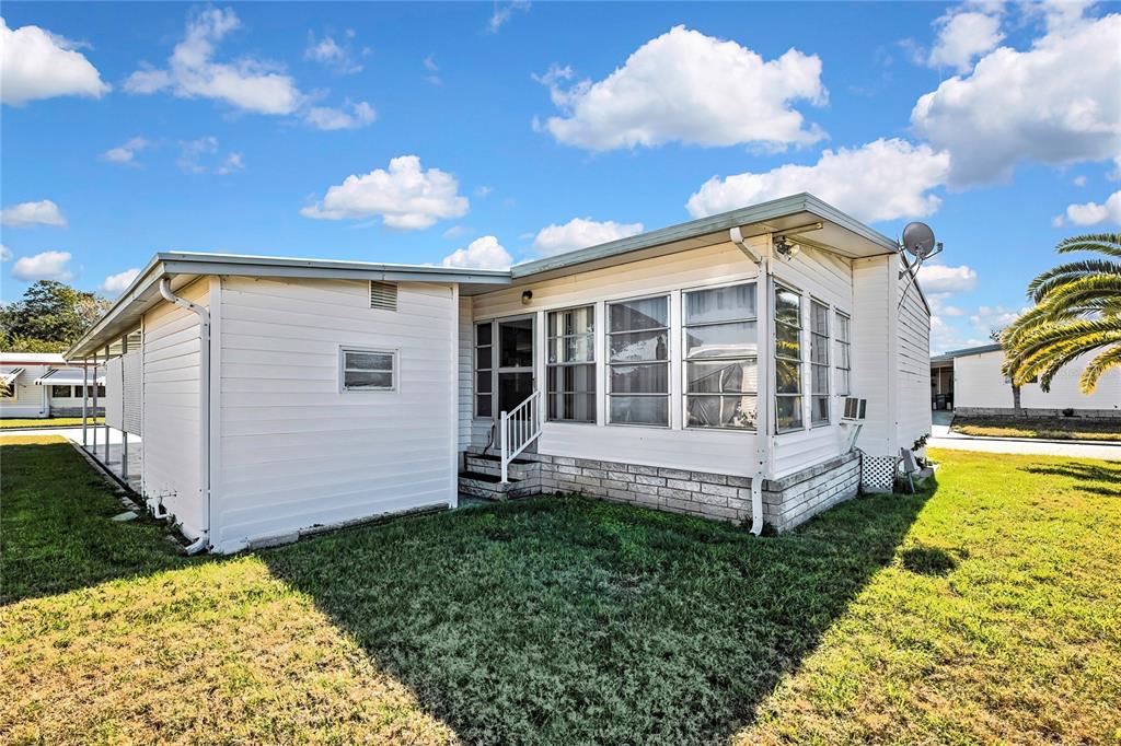 3141 Nantucket Drive Holiday, FL 34690 - Photo 28 of 34 a view of a house with a yard