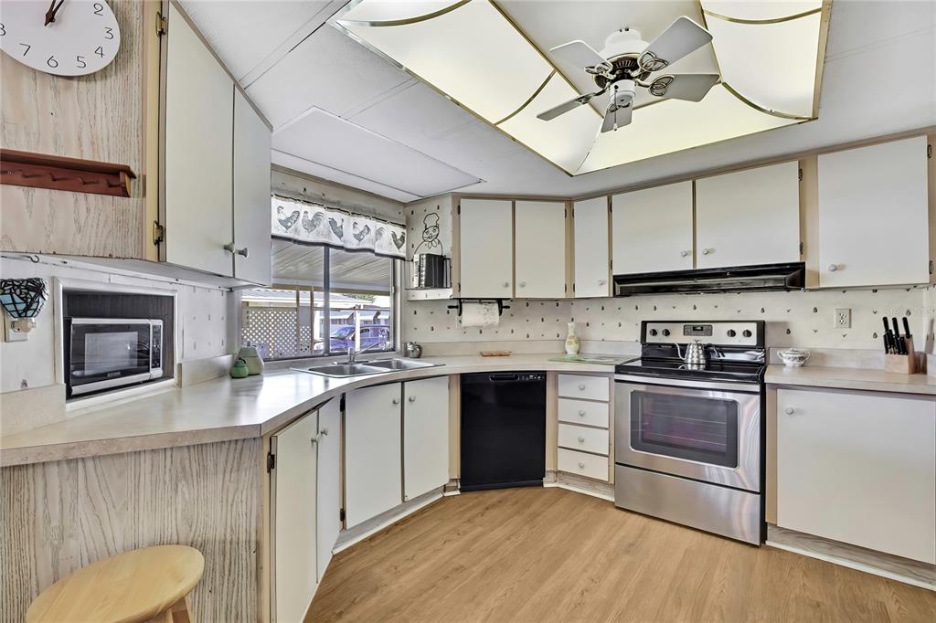 3141 Nantucket Drive Holiday, FL 34690 - Photo 7 of 34 a kitchen with stainless steel appliances granite countertop a sink a stove and cabinets