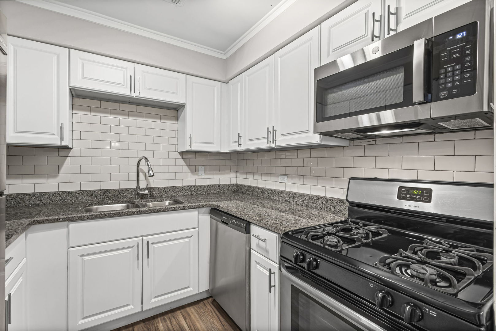 14457 Lamon Avenue, Unit 3N Midlothian, IL 60445 - Photo 12 of 21 a kitchen with granite countertop stainless steel appliances and white cabinets