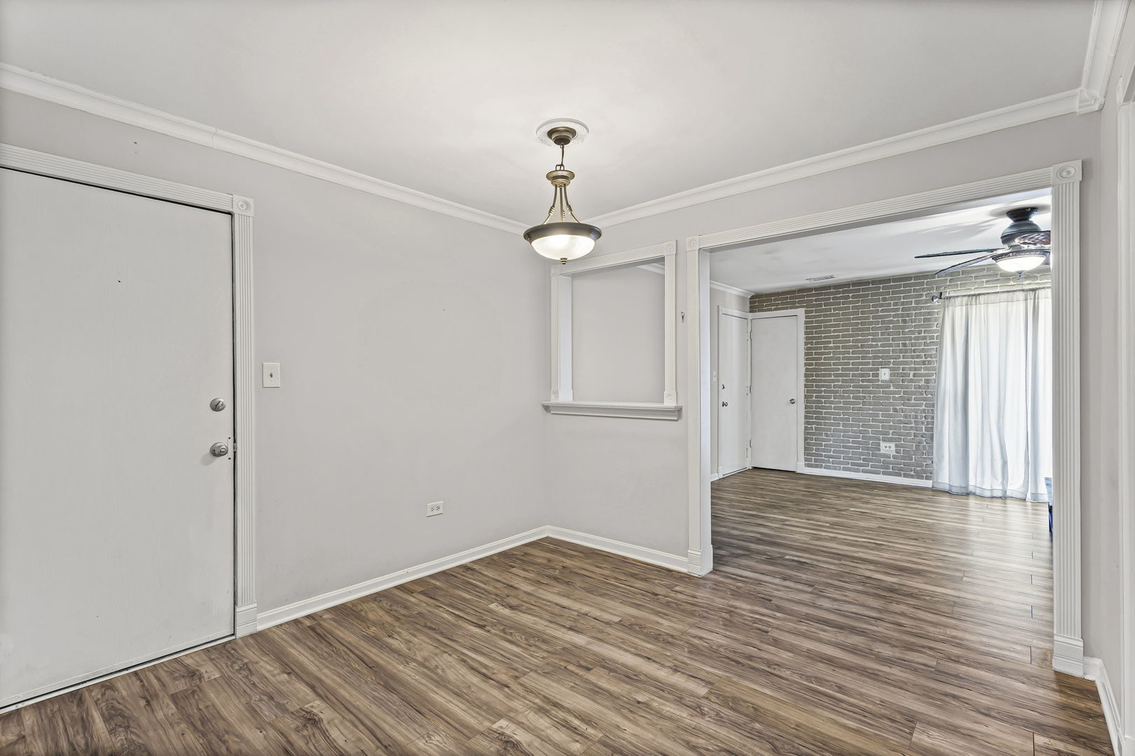 14457 Lamon Avenue, Unit 3N Midlothian, IL 60445 - Photo 7 of 21 a view of an empty room with wooden floor and a window