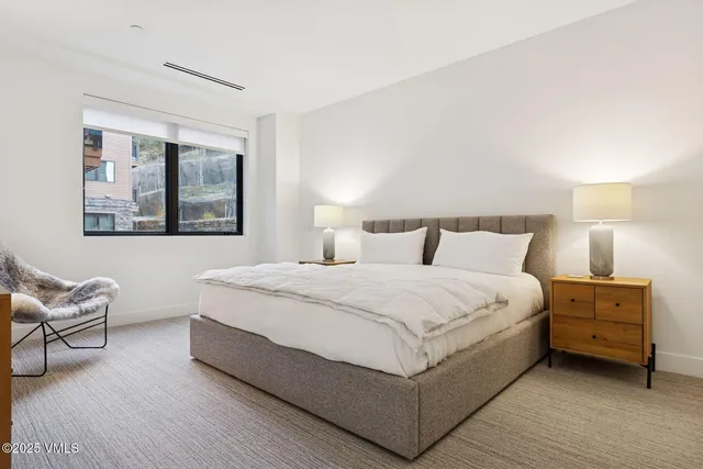 a bedroom with a bed and window