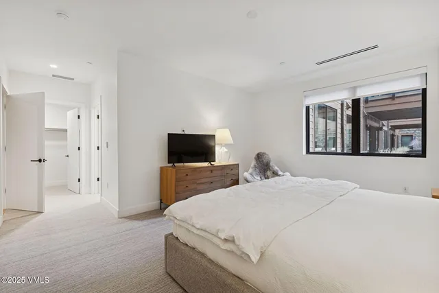 a bedroom with a bed and a television