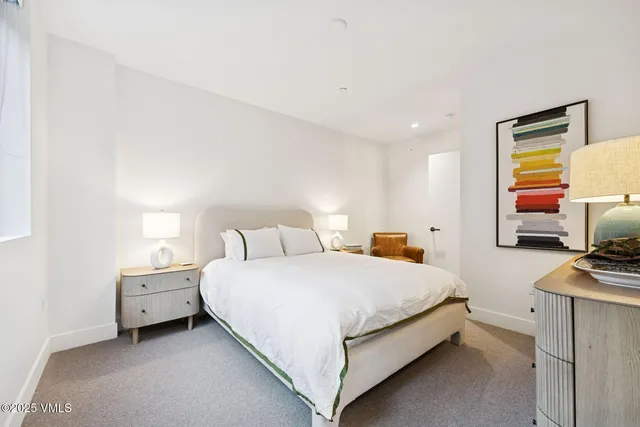 a bedroom with a bed and a night stand