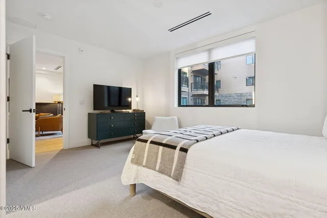 a bedroom with a bed and a television in it