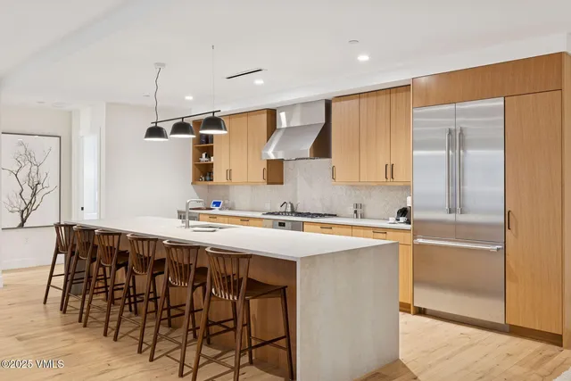 a kitchen with a stove a sink and a refrigerator
