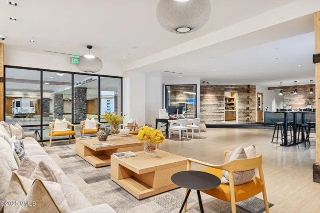 a view of a hallway with elevator and wooden floor