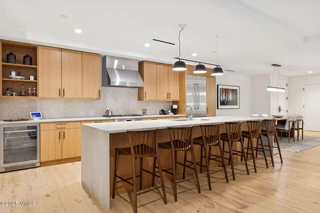 a kitchen with granite countertop a table chairs sink and cabinets