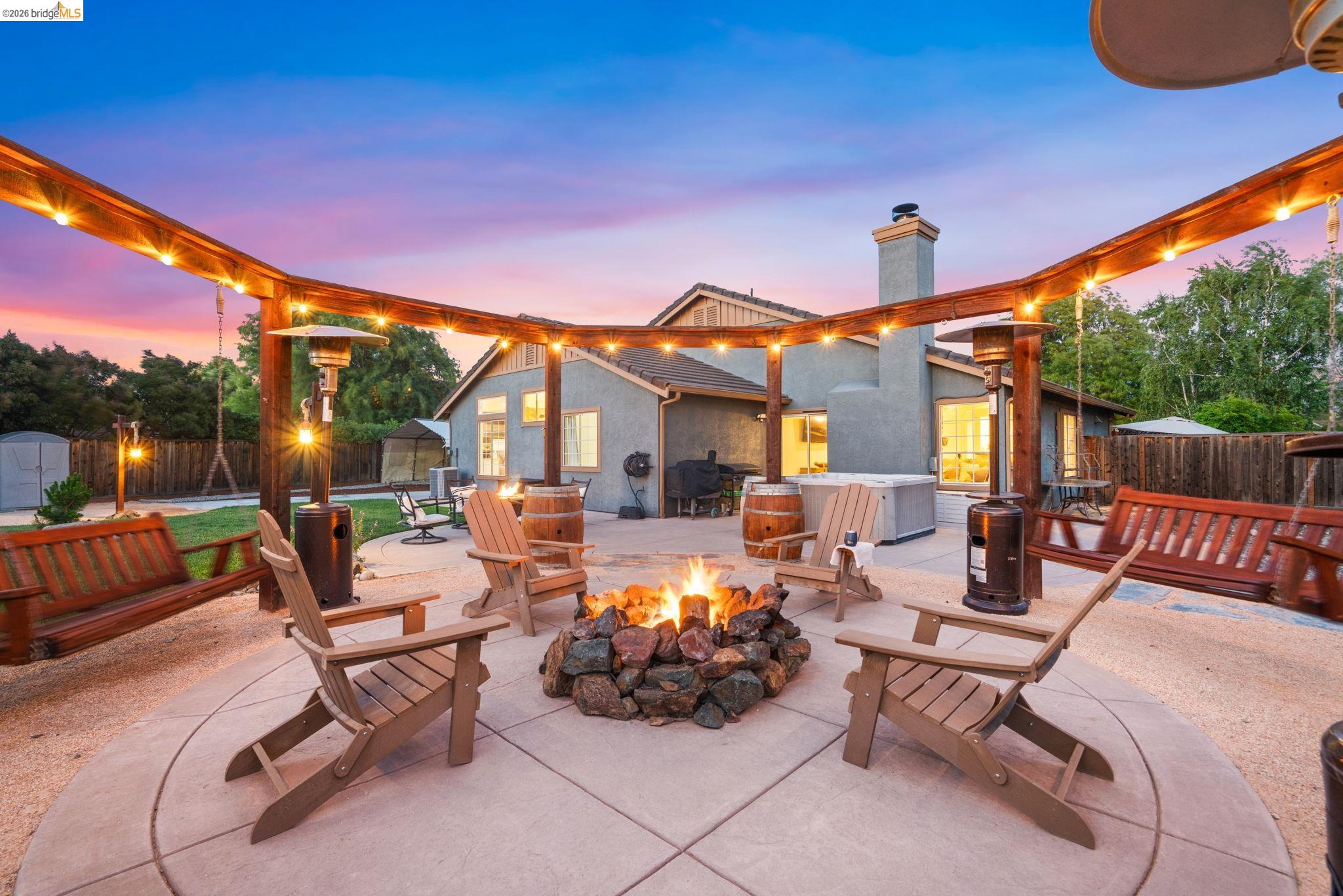 1186 El Rio Court Livermore, CA 94551 - Photo 31 of 60 Outdoor entertainment area featuring a circular concrete patio with a stone fire pit