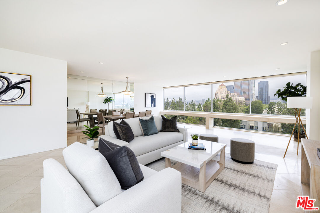a living room with furniture and a floor to ceiling window