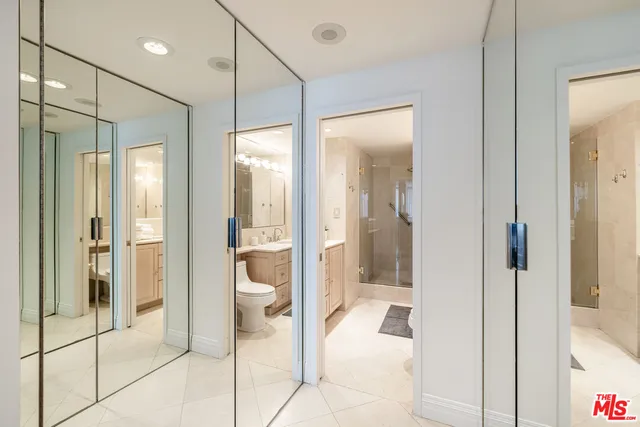 a bathroom with a glass shower door and a glass door shower