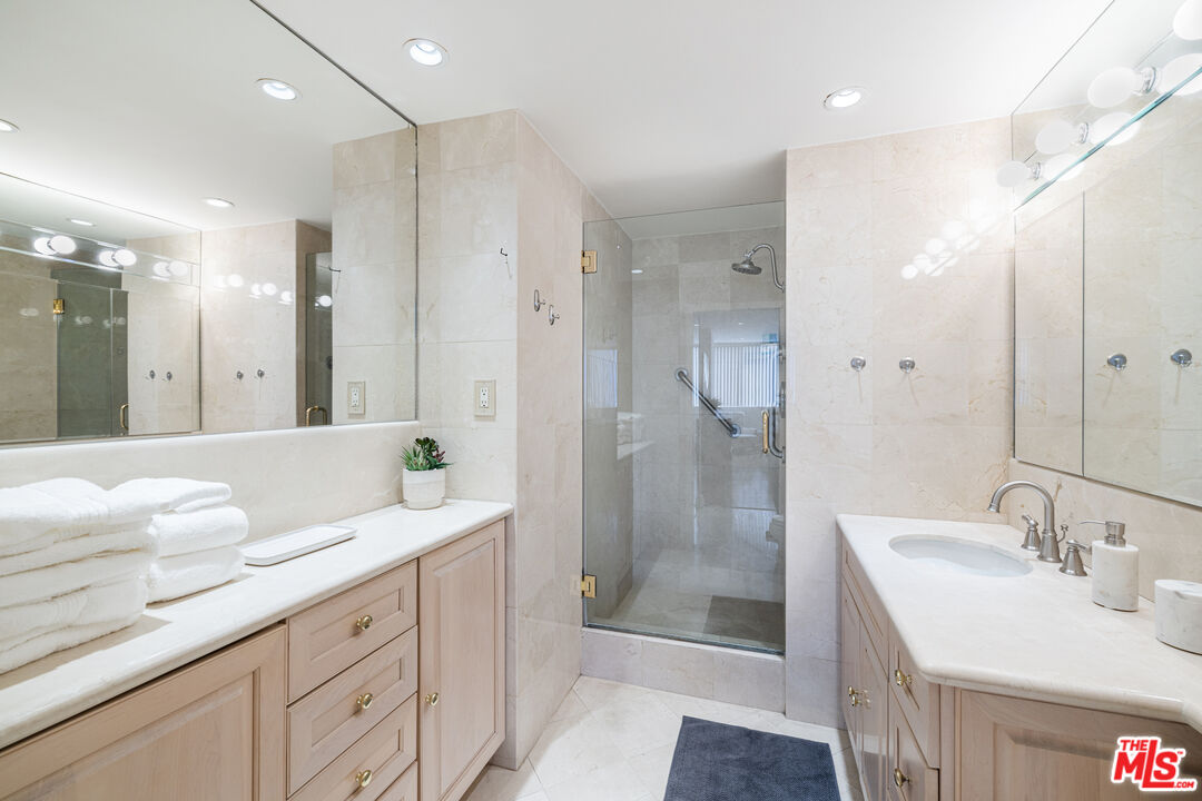 2220 Avenue Of The Stars, Unit 803 Los Angeles, CA 90067 - Photo 12 of 25 a spacious bathroom with a shower sink and mirror