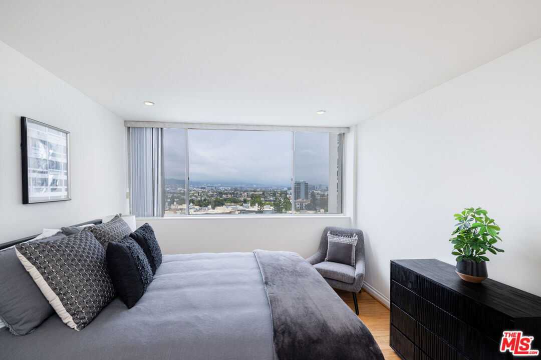 2220 Avenue Of The Stars, Unit 803 Los Angeles, CA 90067 - Photo 14 of 25 a bed room with a bed window and a couch