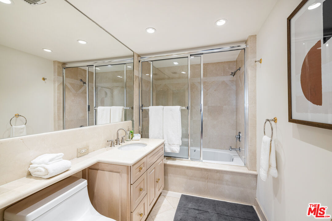 2220 Avenue Of The Stars, Unit 803 Los Angeles, CA 90067 - Photo 15 of 25 a bathroom with a tub sink a mirror and a shower