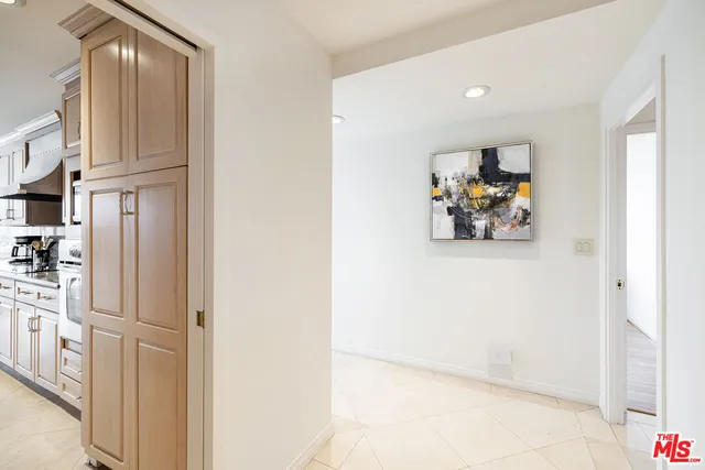a view of kitchen with furniture and refrigerator
