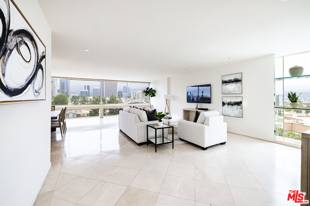 2220 Avenue Of The Stars, Unit 803 Los Angeles, CA 90067 - Photo 18 of 25 a living room with furniture and a large window